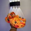 dff4b70e-0250-4c04-888a-863b99dd4044 Orange Camo Charm Clogs